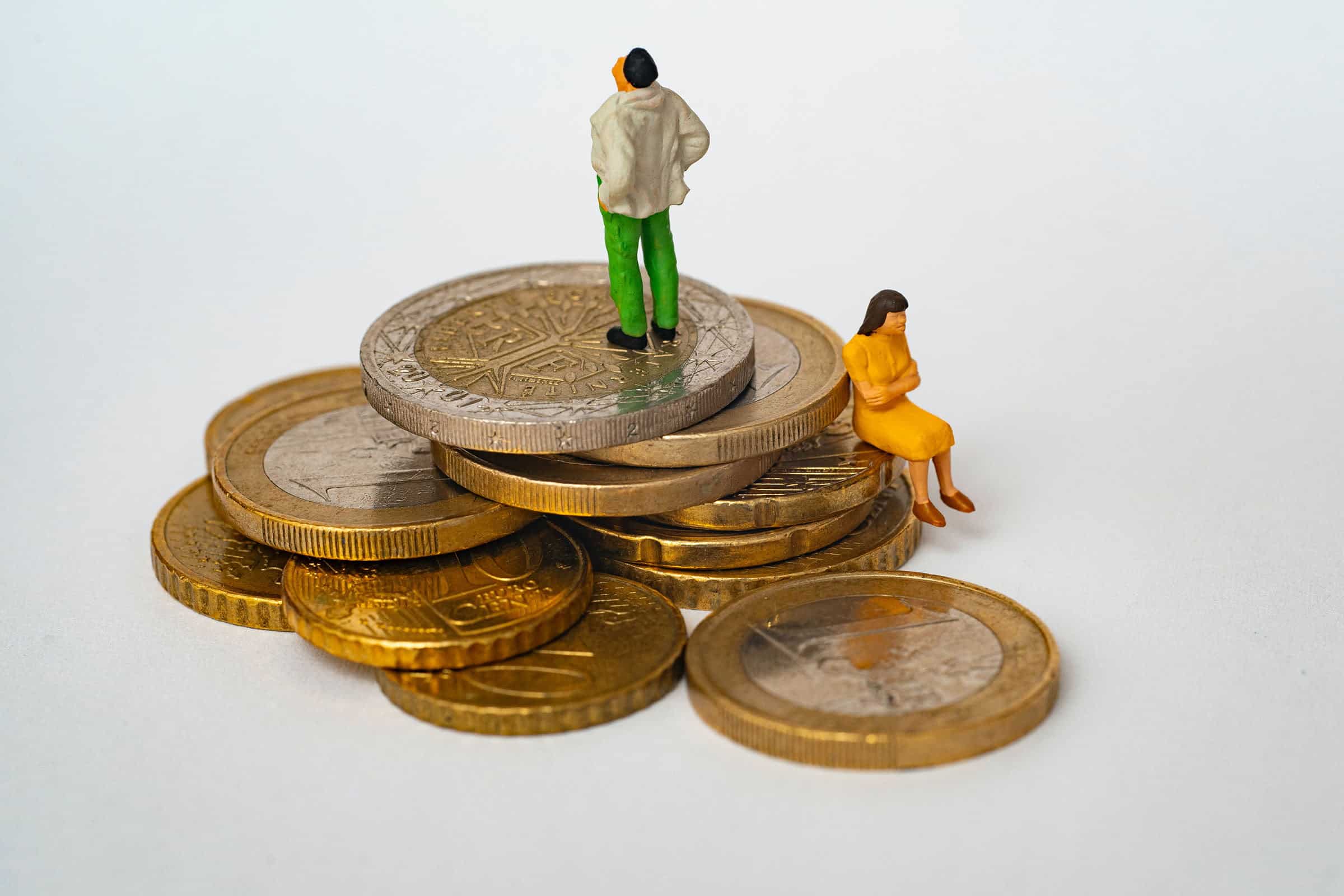 pile of money with couple sitting on it